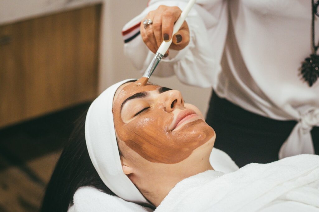 Client receiving a relaxing facial skincare treatment in Bucharest